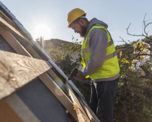 Tampa roofing contractor inspecting damaged roof for repair and maintenance